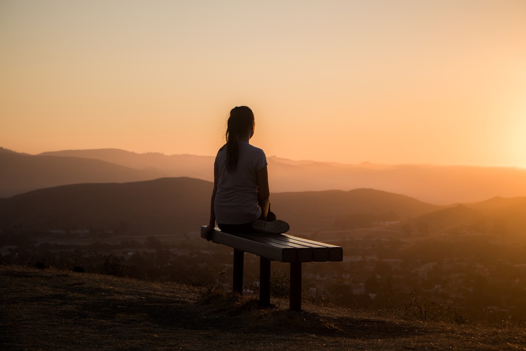 A person sitting peacefully in meditation, journaling to clarify and embrace the new higher purpose emerging in their life.